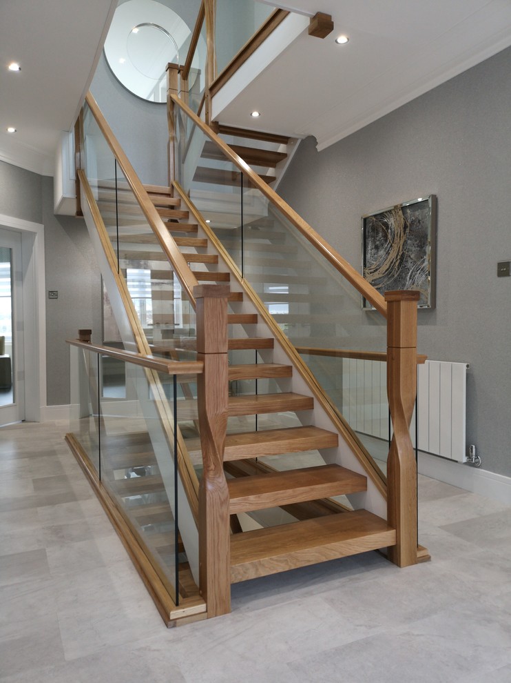 Photo of a modern wood floating wood railing staircase in Glasgow with open risers.