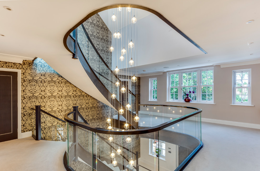 Contemporary glass railing staircase in Surrey with a feature wall.