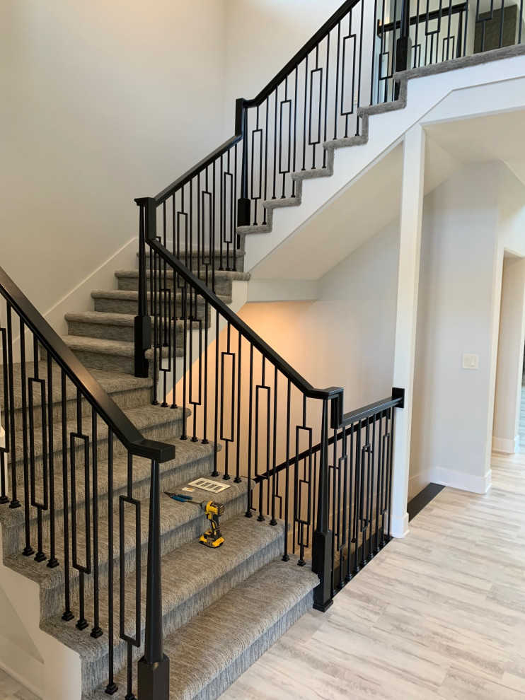 Staircase - mid-sized modern carpeted u-shaped metal railing staircase idea in Omaha with carpeted risers
