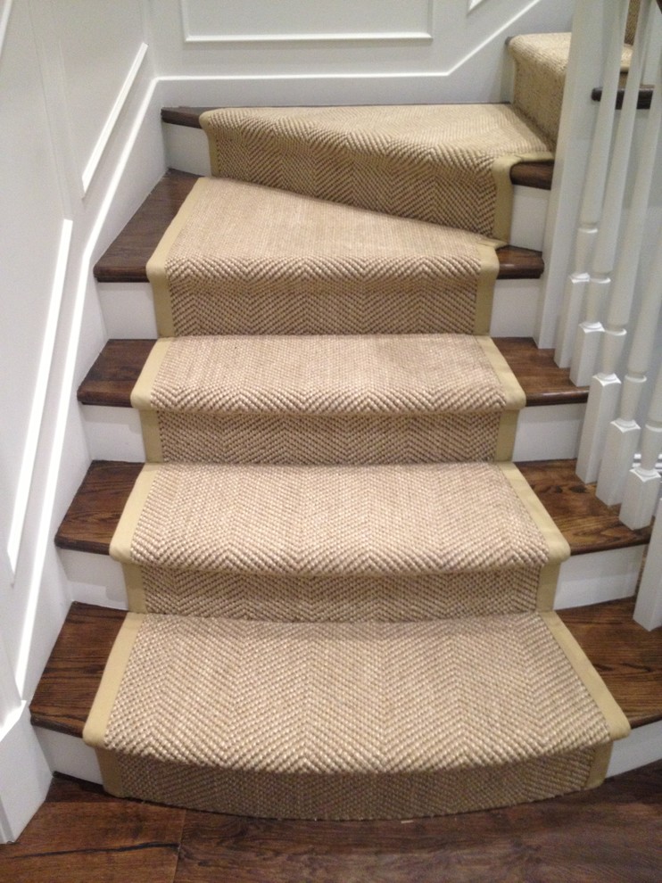 This is an example of a medium sized classic wood curved staircase in Chicago with wood risers.