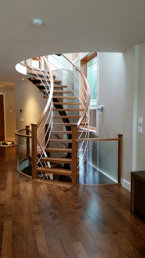 Design ideas for a medium sized contemporary wood floating staircase in Vancouver with open risers.