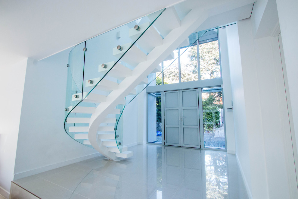 Staircase - modern curved open staircase idea in London