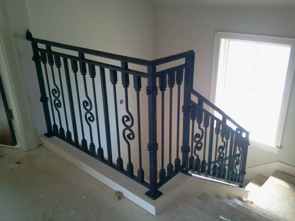 Example of a mid-sized transitional l-shaped staircase design in Oklahoma City