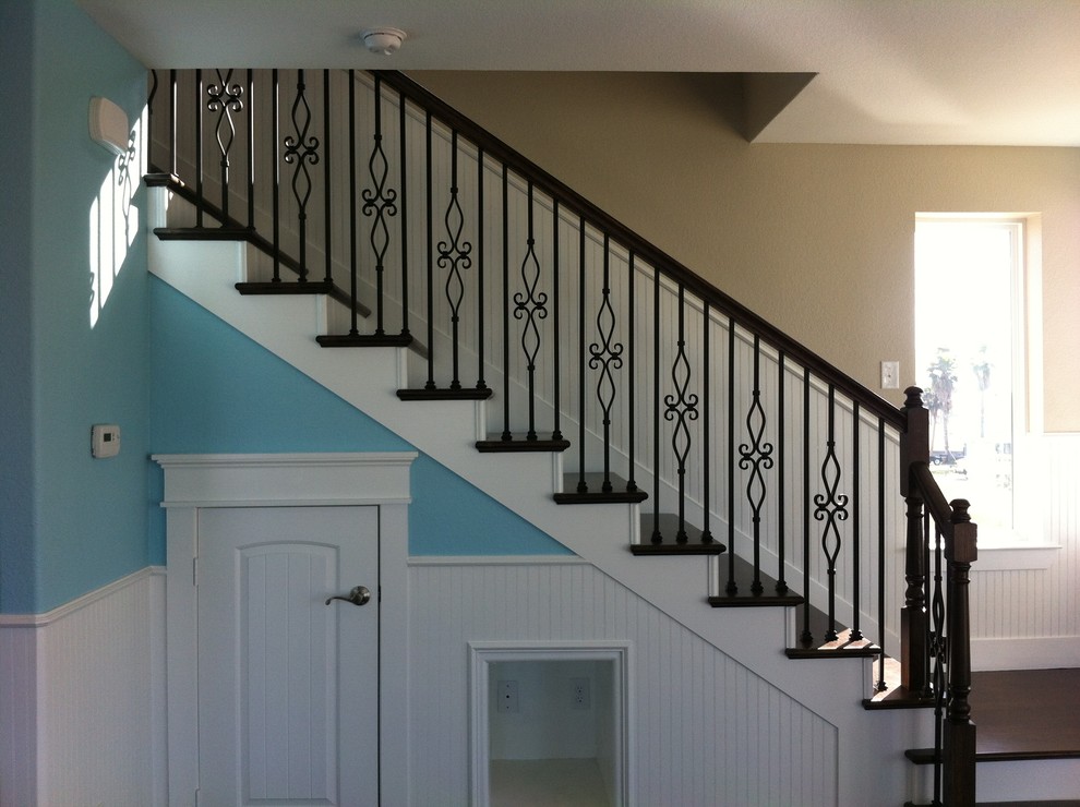 Photo of a medium sized traditional wood l-shaped staircase in Houston with painted wood risers.