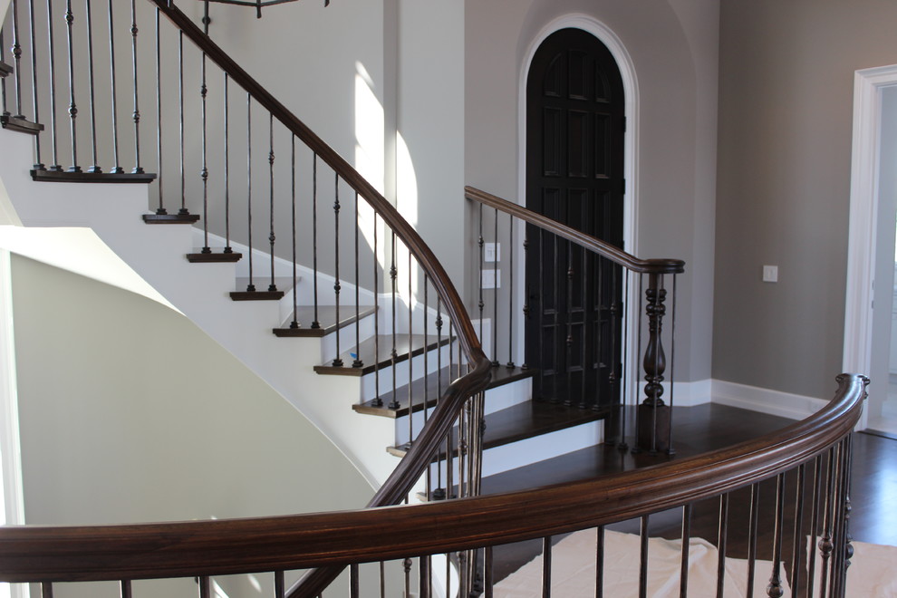 Inspiration for an expansive nautical wood spiral mixed railing staircase in Other with wood risers.