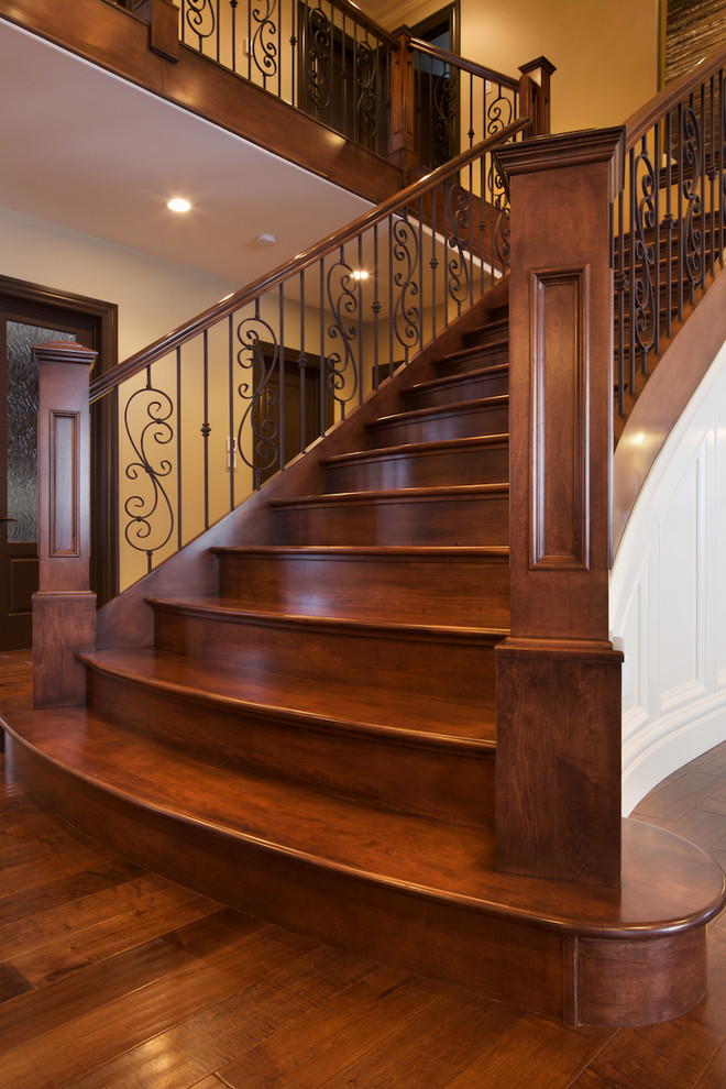 Elegant wooden straight staircase photo in Edmonton with wooden risers