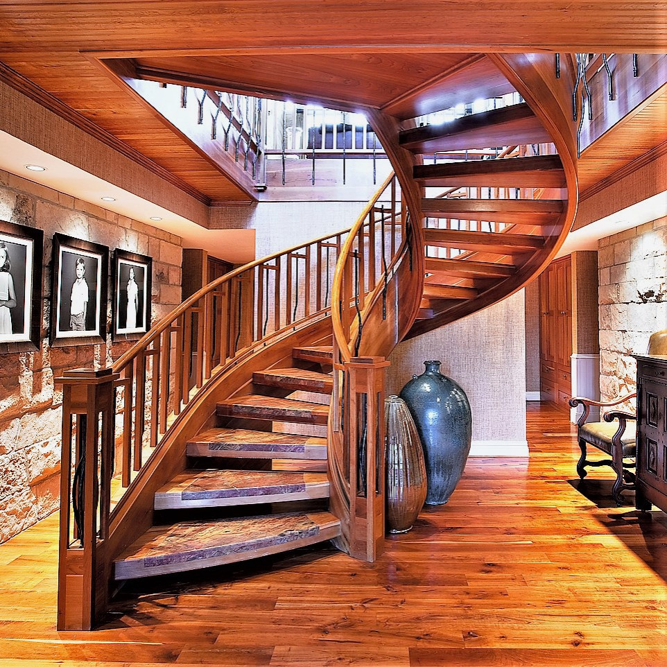 This is an example of a rustic curved mixed railing staircase in Salt Lake City with open risers.