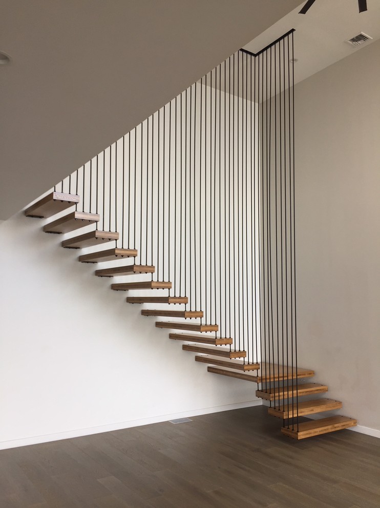 Staircase - modern wooden floating metal railing staircase idea in New York