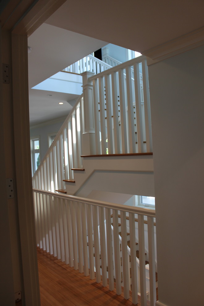 Example of a transitional wooden wood railing staircase design in Other with wooden risers
