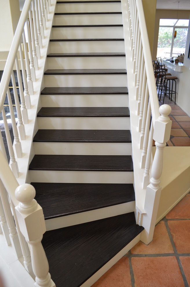 Photo of a small contemporary wood straight staircase in San Diego with painted wood risers.