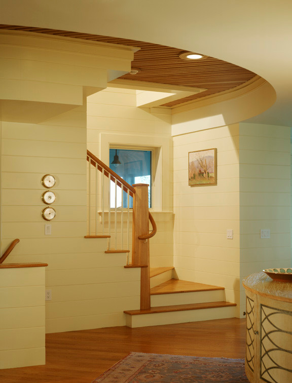 Example of a large minimalist wooden curved staircase design in Providence with wooden risers