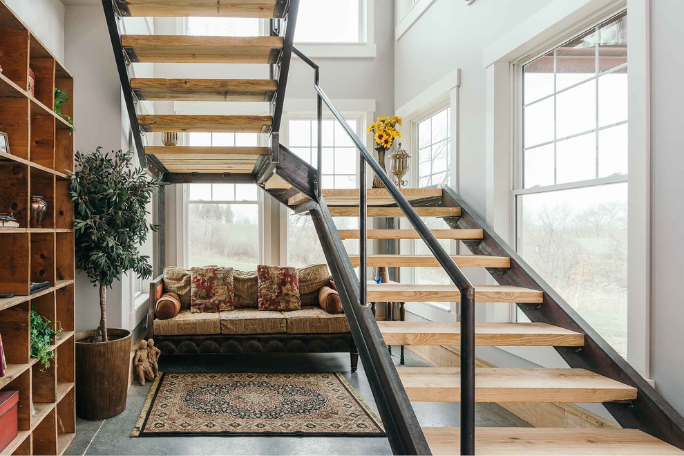 Inspiration for an expansive industrial wood curved staircase in Other.