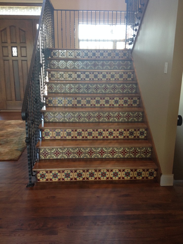 Photo of a large mediterranean wood u-shaped metal railing staircase in Other with tiled risers.