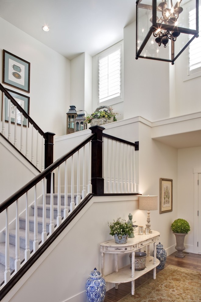 Example of a classic carpeted u-shaped staircase design in Salt Lake City with carpeted risers