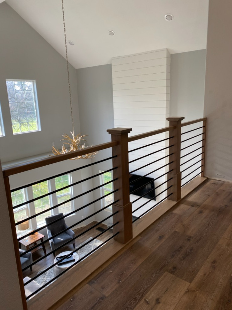 Стильный дизайн: большая угловая лестница в современном стиле с деревянными ступенями, крашенными деревянными подступенками и перилами из смешанных материалов - последний тренд