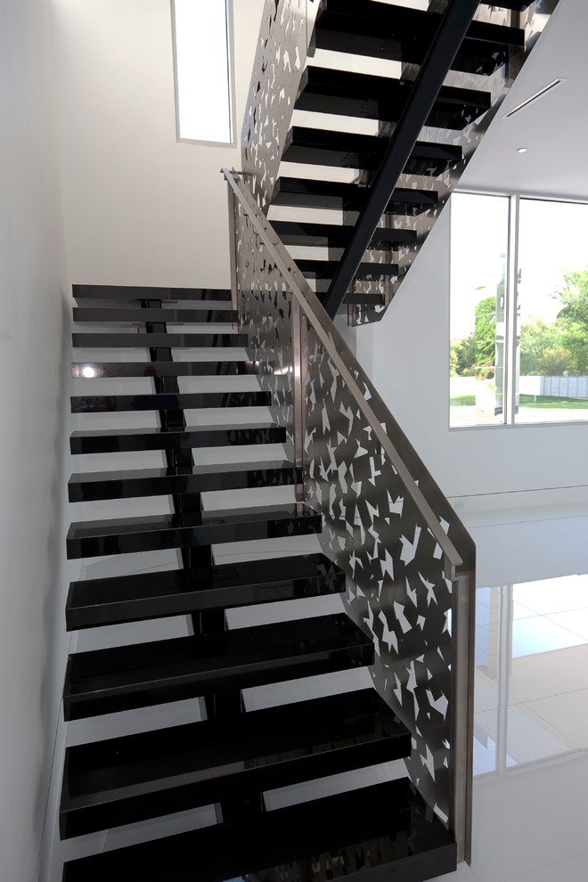 Staircase - large tile floating staircase idea in Dallas with metal risers