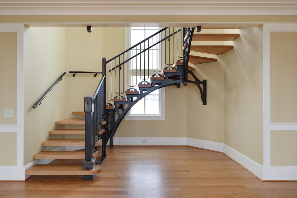 Example of a large trendy wooden curved metal railing and open staircase design in Other