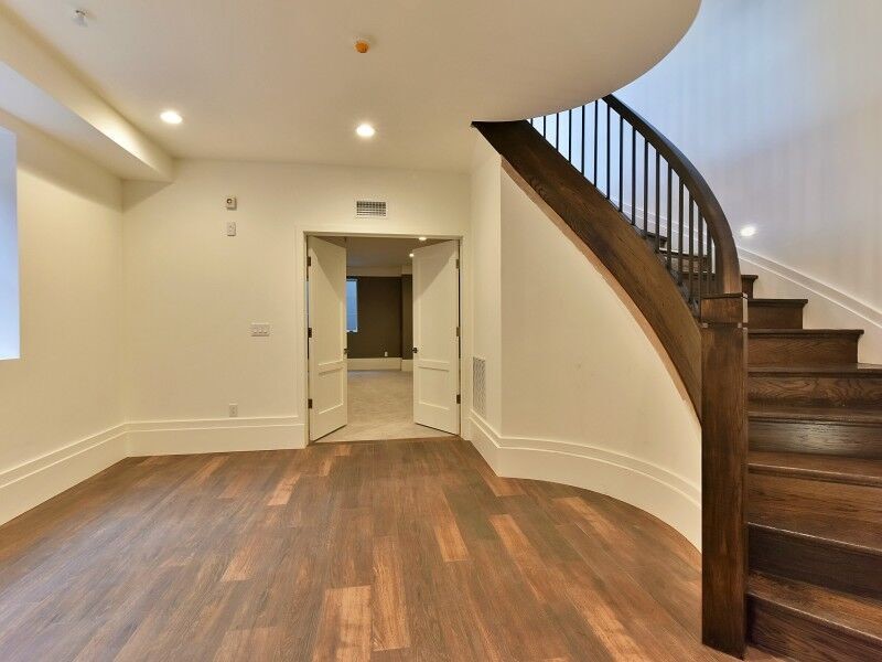 Design ideas for a large traditional wood curved staircase in New York with wood risers.