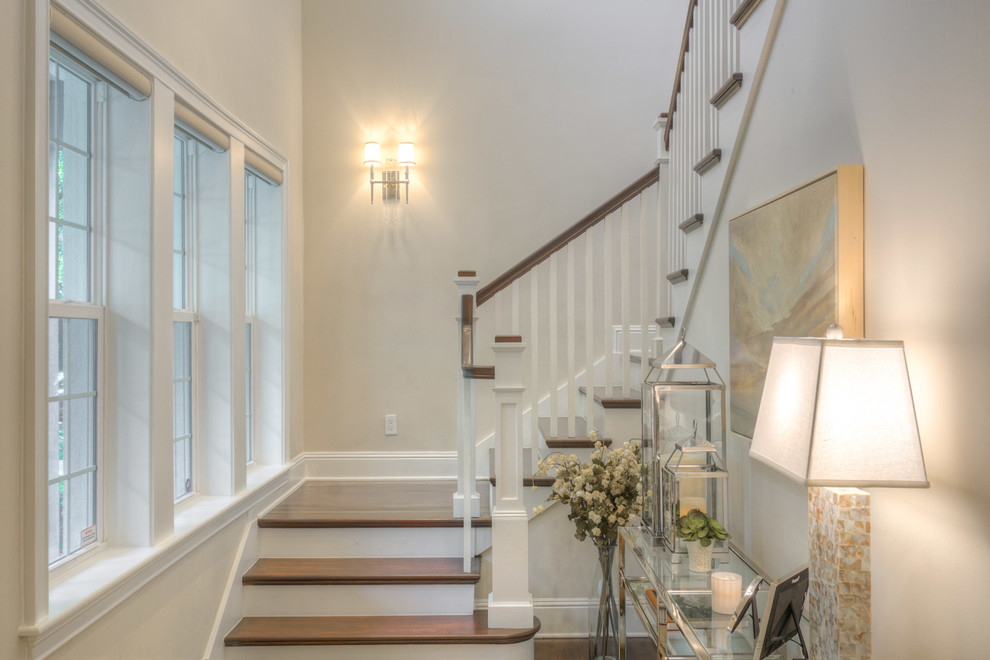 Inspiration for a large classic wood u-shaped wood railing staircase in Tampa with painted wood risers and feature lighting.