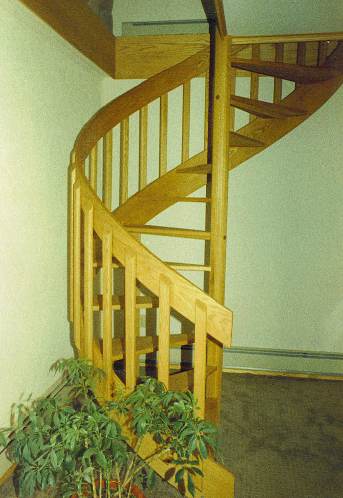 Foto di una piccola scala a chiocciola con pedata in legno e nessuna alzata
