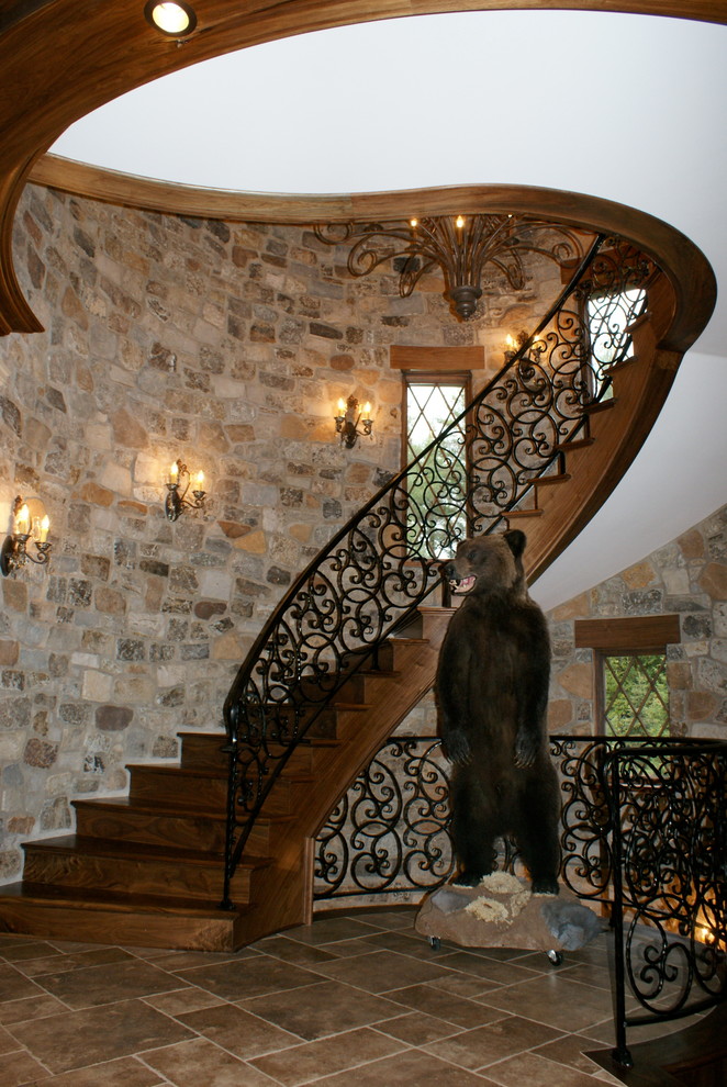Diseño de escalera curva mediterránea con escalones de madera y contrahuellas de metal