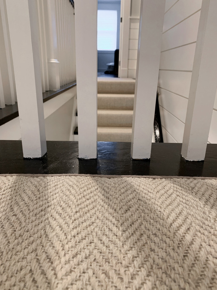 Large carpeted l-shaped staircase in Boston.