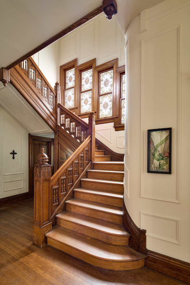 This is an example of a victorian wood l-shaped staircase in San Francisco with wood risers.