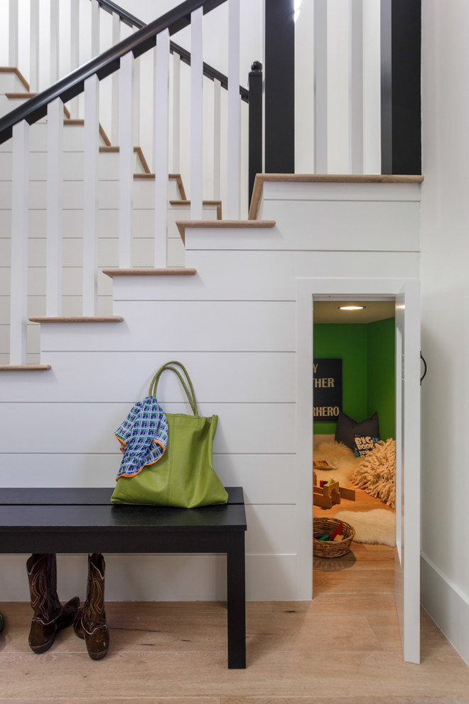 Example of a transitional wooden u-shaped staircase design in Los Angeles