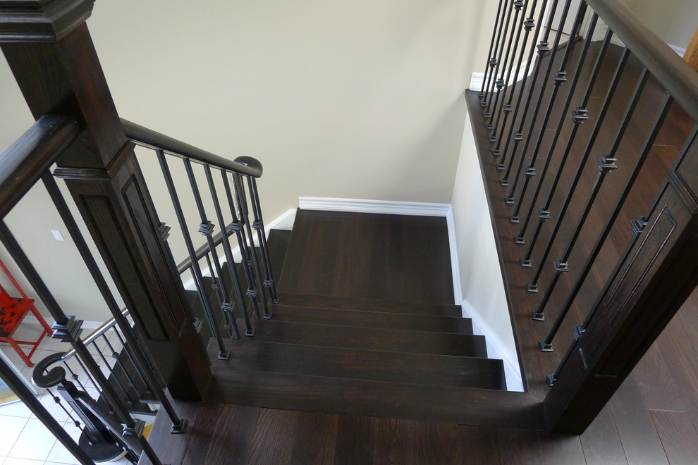 Foto de escalera en L actual de tamaño medio con escalones de madera, contrahuellas de madera pintada y barandilla de madera