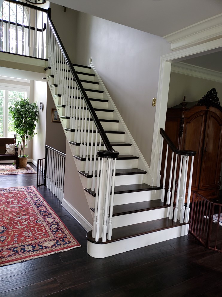 This is an example of a medium sized traditional wood l-shaped wood railing staircase in Philadelphia with painted wood risers.