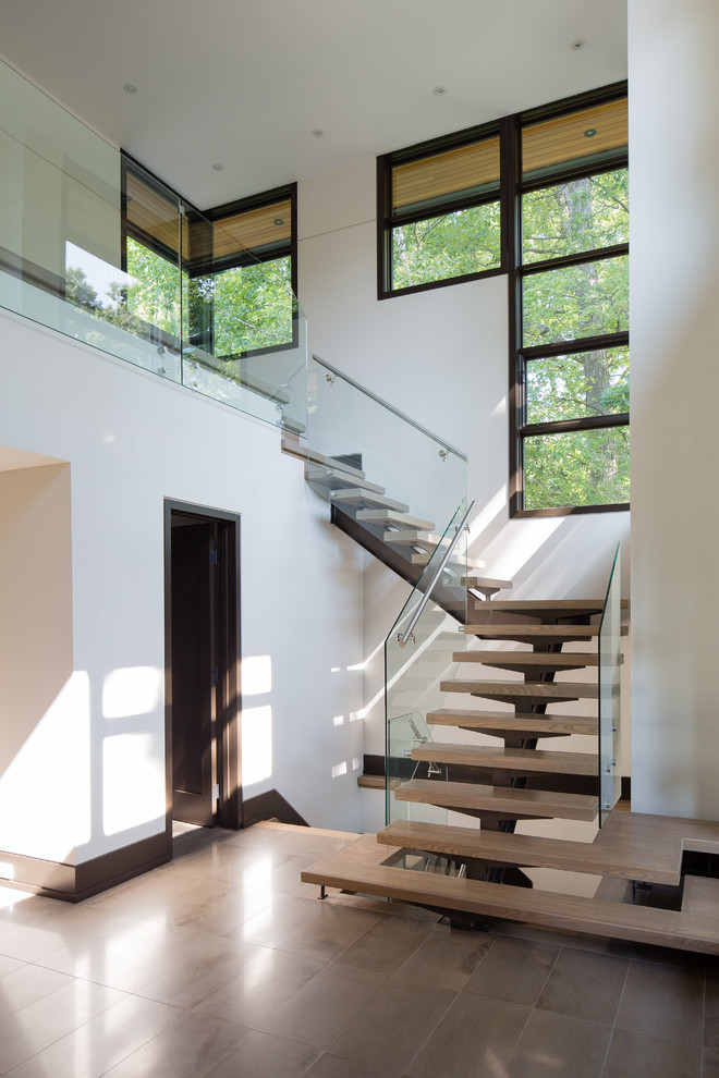 Large trendy wooden floating open staircase photo in Toronto