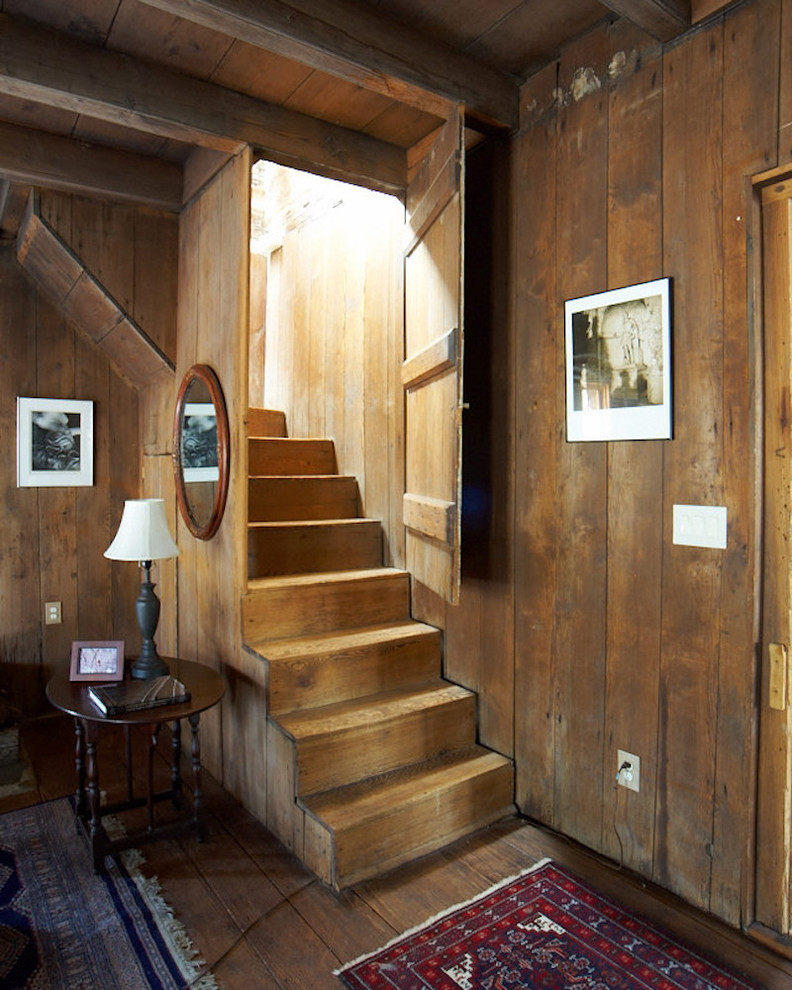 Inspiration for a rustic wood staircase in Charlotte with wood risers and feature lighting.