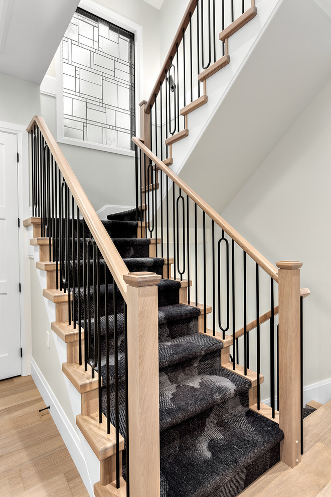 Inspiration for a small modern carpeted u-shaped wood railing staircase in Vancouver with carpeted risers.