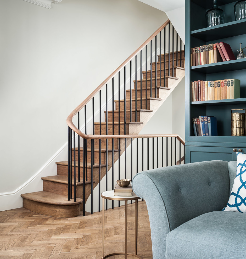 Inspiration for a large timeless wooden straight staircase remodel in London with wooden risers