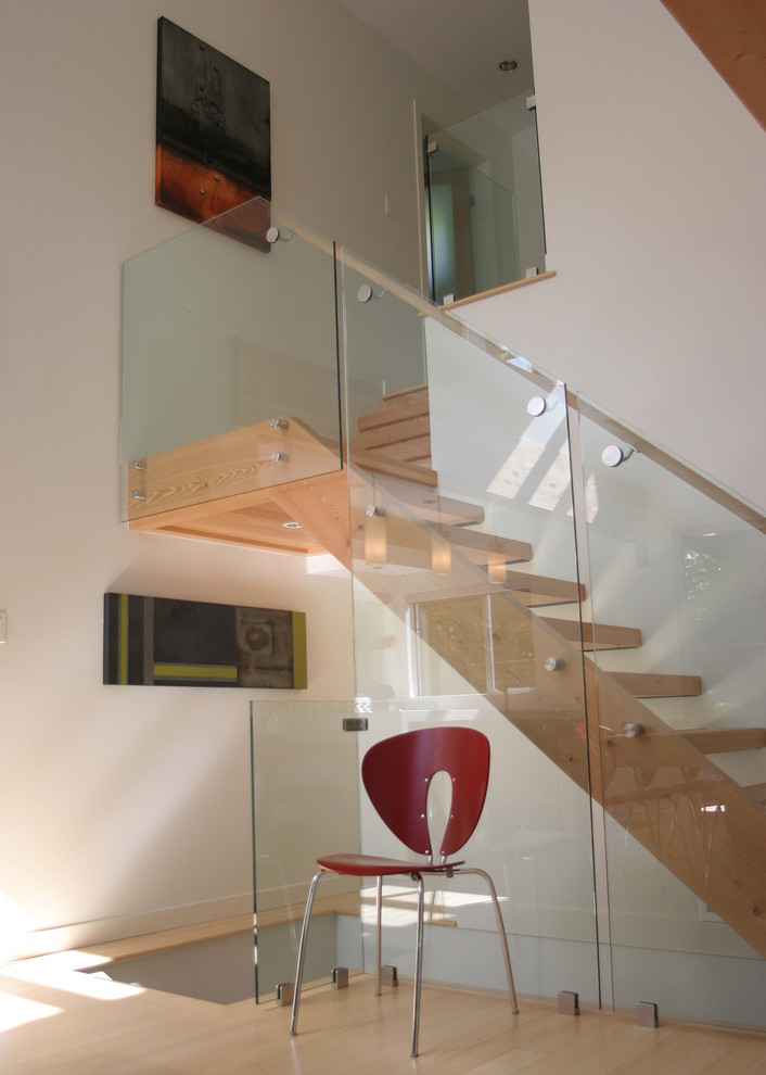 Photo of a contemporary wood staircase in Vancouver with open risers.