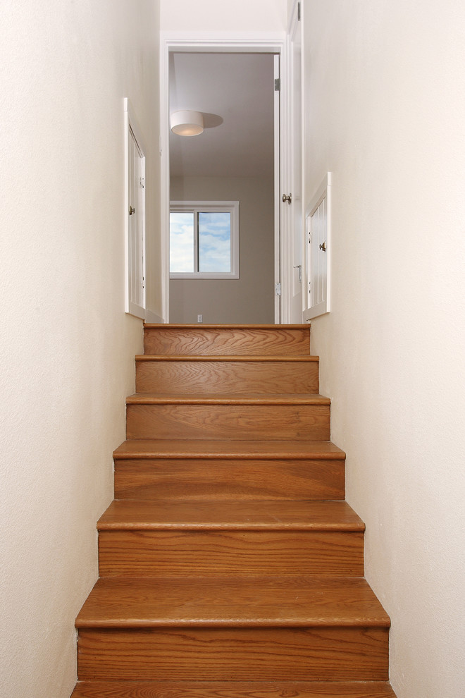 Photo of a small contemporary wood straight staircase in San Francisco with wood risers.