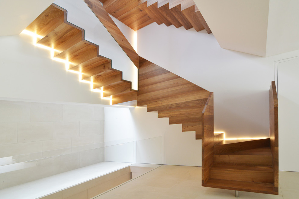 Inspiration for a large contemporary metal u-shaped staircase in London with metal risers.