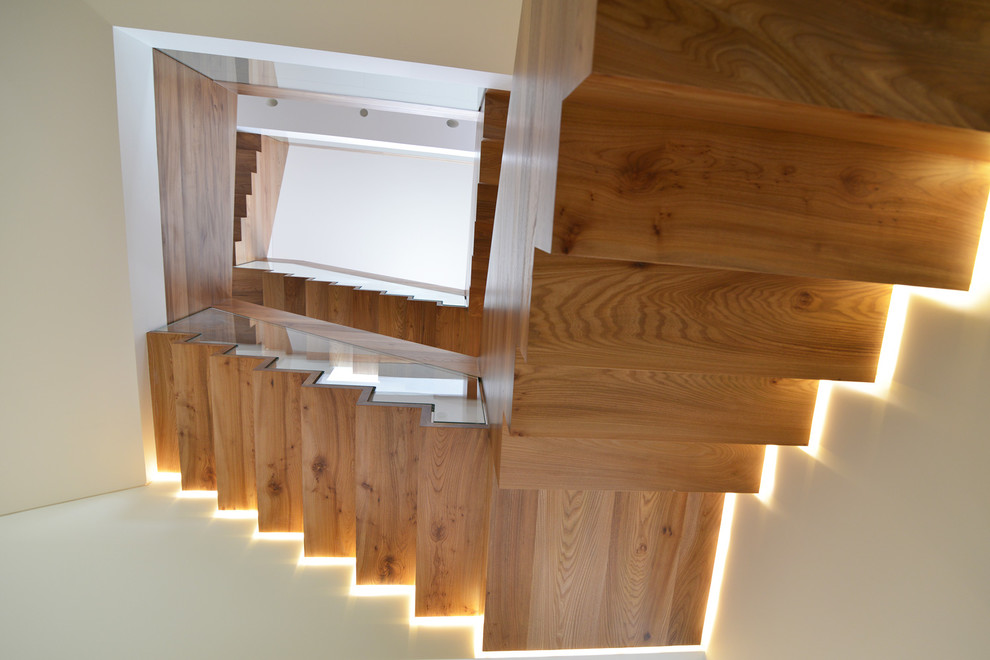 Large contemporary metal u-shaped staircase in London with metal risers.