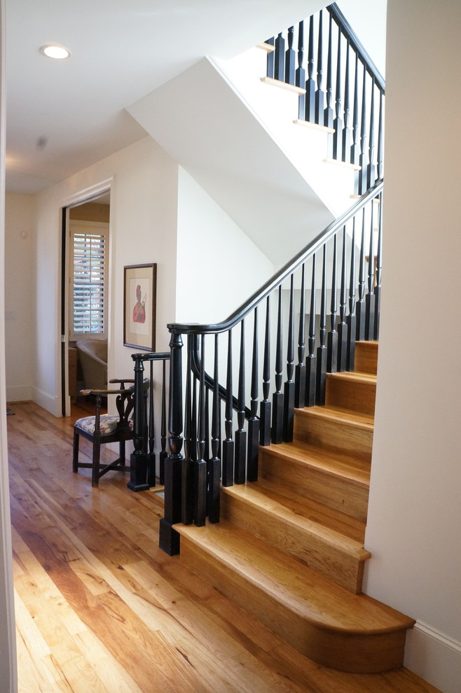 Inspiration for a mid-sized wooden u-shaped staircase remodel in Denver with wooden risers