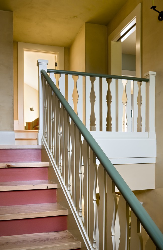 Example of a classic wooden wood railing staircase design in Burlington with painted risers
