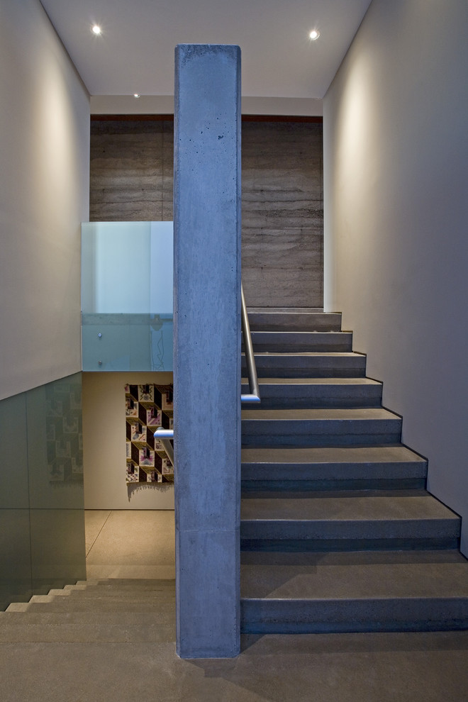 Example of a trendy concrete u-shaped staircase design in Phoenix with concrete risers