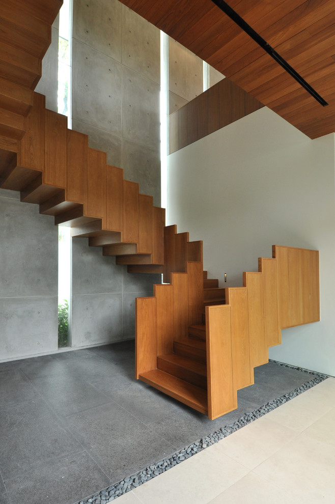 Inspiration for a contemporary wood staircase in Singapore with wood risers.