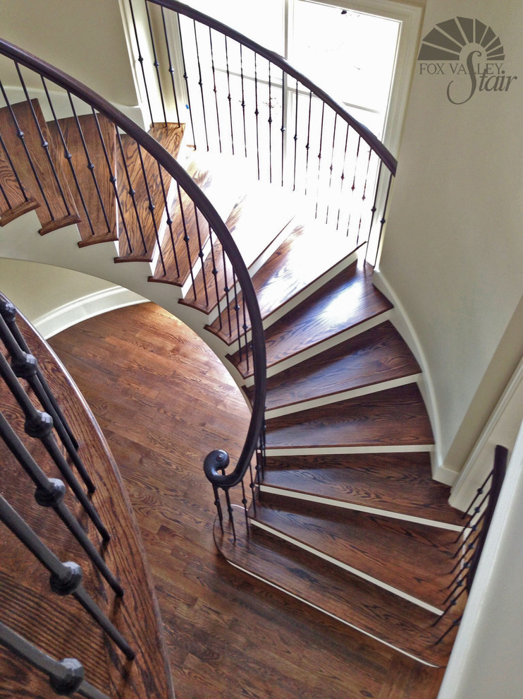 Inspiration for a mid-sized eclectic wooden curved staircase remodel in Chicago with wooden risers