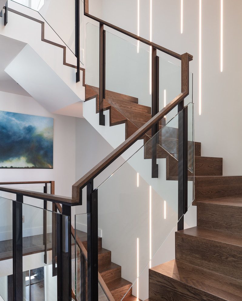 Idée de décoration pour un escalier design en U avec des marches en bois, des contremarches en bois, un garde-corps en matériaux mixtes et palier.