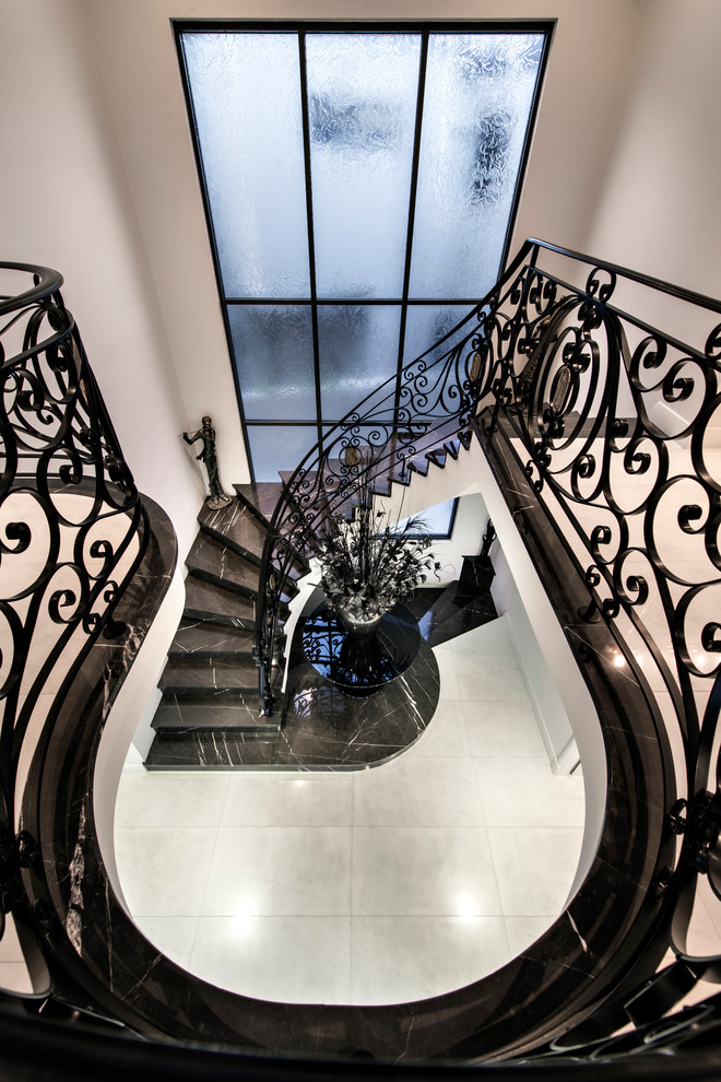 Example of a huge tuscan curved staircase design in Perth