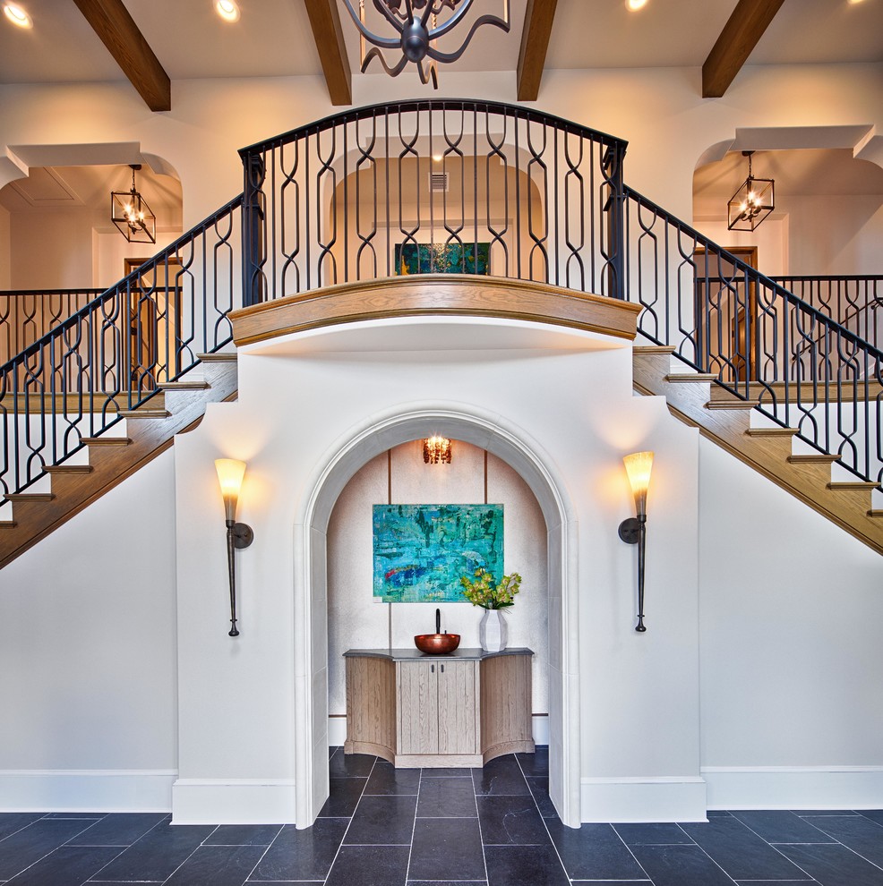 Photo of a mediterranean wood straight metal railing staircase in Orlando with wood risers.