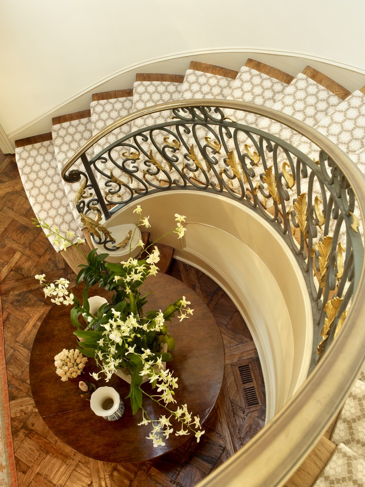 Example of a large classic carpeted curved wood railing staircase design in San Francisco with carpeted risers
