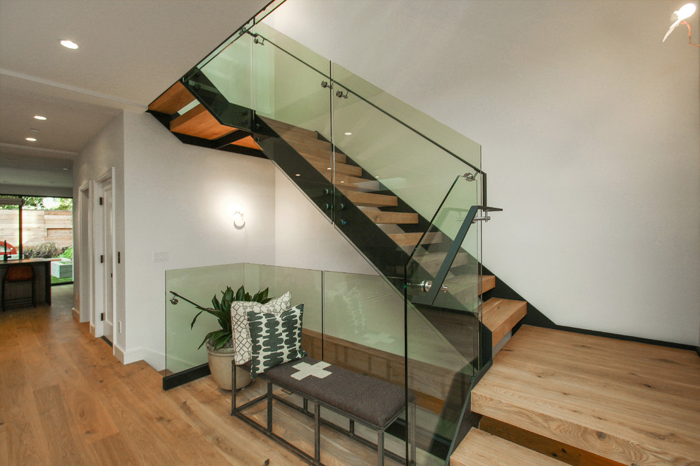 This is an example of a large contemporary wood l-shaped mixed railing staircase in San Francisco with open risers.