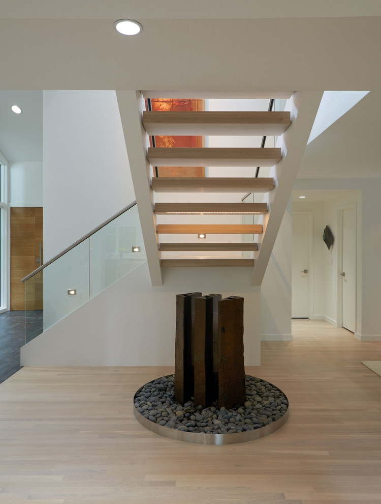 Design ideas for a modern wood l-shaped staircase in Portland with open risers and feature lighting.