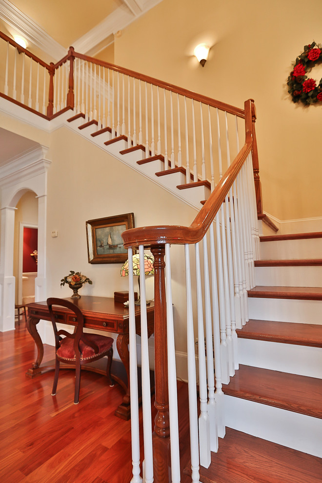 Large elegant wooden l-shaped staircase photo in Atlanta with painted risers